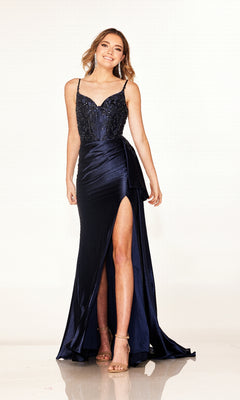 A woman stands elegantly in the Long Prom Dress: Cecilia Couture 2605—a blue, form-fitting gown with a rhinestone corset bodice and a thigh-high leg slit that adds a touch of allure.