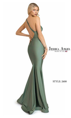 A woman wears the Jessica Angel 2608 Long Prom Dress—a fitted, floor-length sage green mermaid gown with an open back and chic one-shoulder design, perfect for making a statement at any special event.