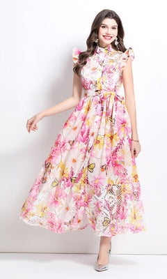 Woman in an A-Line Floral-Print Casual Maxi Dress with Buttons, Pink Multi, sleeveless and ankle-length, posing against a plain white background.