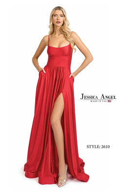 Woman in a red Jessica Angel 2610 long prom dress with spaghetti straps and thigh-high slit, posing with hands in pockets. Text reads: "Jessica Angel 2610 Long Prom Dress – Made in USA.