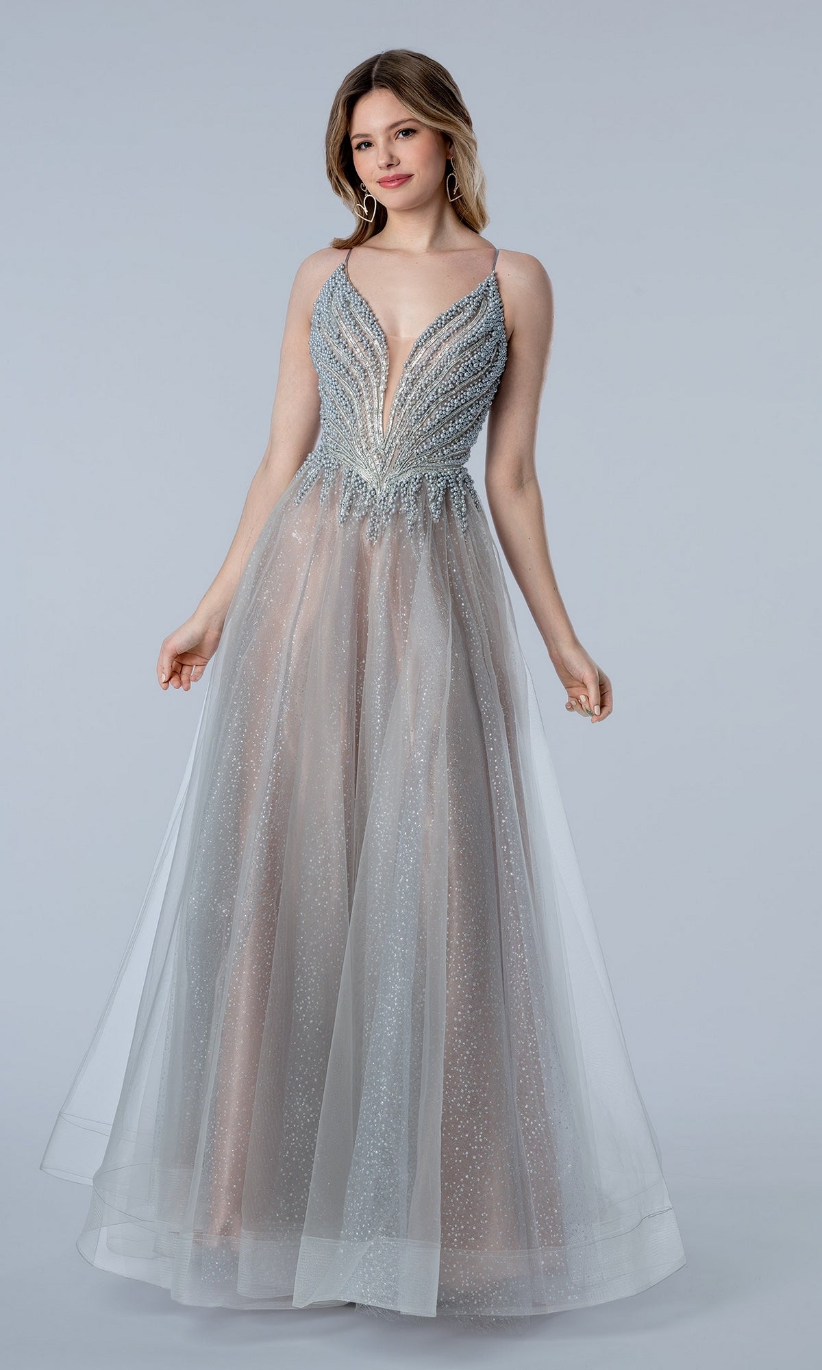 Stella Couture 26112 floor-length silver evening gown with a beaded bodice, deep V-neckline, and a layered tulle skirt.