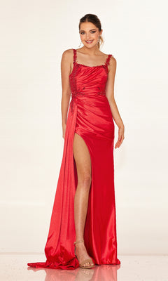 A woman models the Cecilia Couture 2612 long prom dress in red, with a form-fitting silhouette, thigh-high slit, beaded accents, and strappy nude heels.