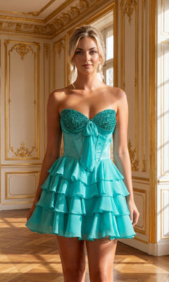 A woman stands in an ornate, gold-trimmed room with large windows, wearing the Poly USA 26134 Ruffled Strapless Mini Hoco Dress in Jade. This short homecoming dress features a beaded sweetheart neckline that adds extra sparkle to its ruffled skirt.