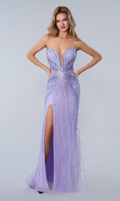 A woman models the Long Prom Dress Stella Couture 26163 in lilac, featuring a strapless design, deep neckline, thigh-high slit, and sparkling rhinestone embellishments against a light grey background.