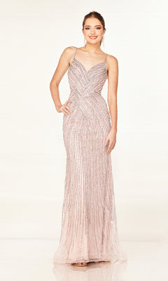 A woman models the Cecilia Couture 2616 long prom dress, featuring light pink sparkly fabric, thin straps, a v-neckline, and vertical sequin details against a plain background.
