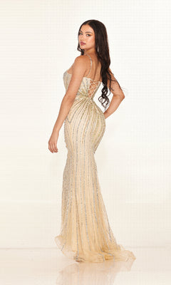 Woman wearing the Cecilia Couture 2616 long prom dress—fitted, floor-length, gold with silver sequin stripes, v-neckline, and thin straps—stands against a plain light background, looking over her shoulder.