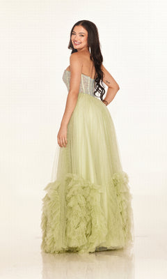A woman smiles in the Cecilia Couture 2617 long prom dress, featuring a strapless rhinestone corset bodice and a light green A-line tulle skirt, set against a plain white background.
