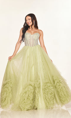 A woman smiles against a plain background wearing the Long Prom Dress: Cecilia Couture 2617—a strapless, light green gown with a rhinestone corset bodice and full ruffled A-line tulle skirt.