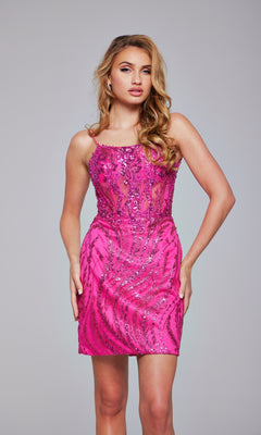 A woman with long wavy hair wears the Jovani Lace-Up Short Red Beaded Party Dress 26183, a sleeveless, fitted dress with sheer panels, standing against a plain light gray background.
