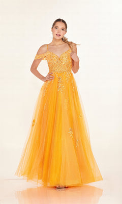 A woman wears the Cecilia Couture 2618 long prom dress with an off-the-shoulder neckline, tulle overlay, and delicate floral embroidery, posing against a plain light background.