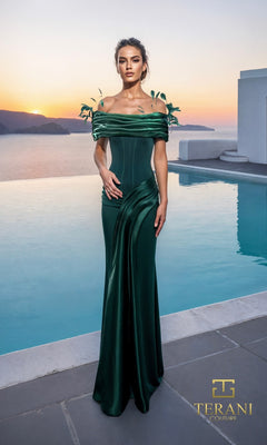 A woman in a hunter Terani 261E6235 long formal dress poses by an infinity pool at sunset, with mountains and water behind her. The off-the-shoulder gown features leaf-like shoulder details.