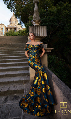 A woman in a teal gold Long Formal Dress (Terani 261E6273) poses on outdoor steps by a stone railing, with a historic building and lush greenery behind her.