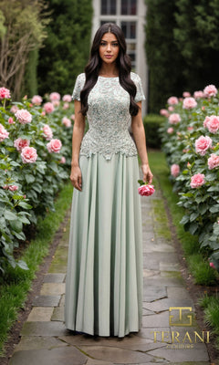 A woman in a sage Terani Couture Long Formal Dress (261M6437) with an embroidered bodice stands on a stone path in a garden of pink roses. The Terani Couture logo appears in the lower right corner.