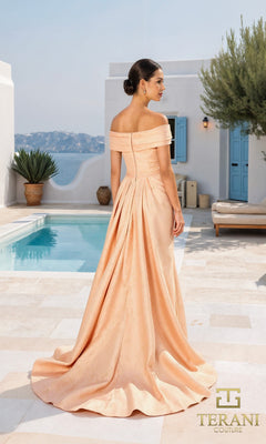 A woman stands by a pool in a sunlit Mediterranean courtyard, wearing the Terani 261M6444 long formal dress?an off-shoulder, peach jacquard gown with a fitted bodice and dramatic train.