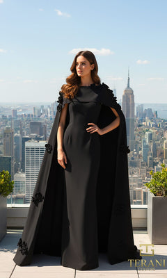 A woman in a long black Terani 261M6687 formal dress with a cape stands on a rooftop, overlooking the city skyline with the Empire State Building in the background.
