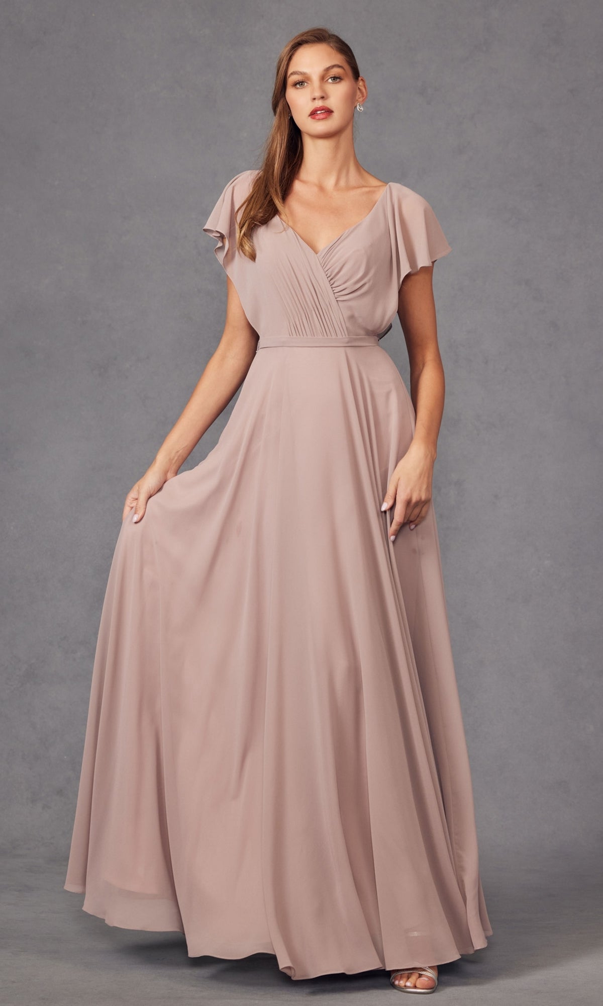 A woman models the Flutter-Sleeve Long Formal Evening Gown 261—a floor-length, mauve A-line dress with flutter sleeves and a V-neckline—against a plain gray background.