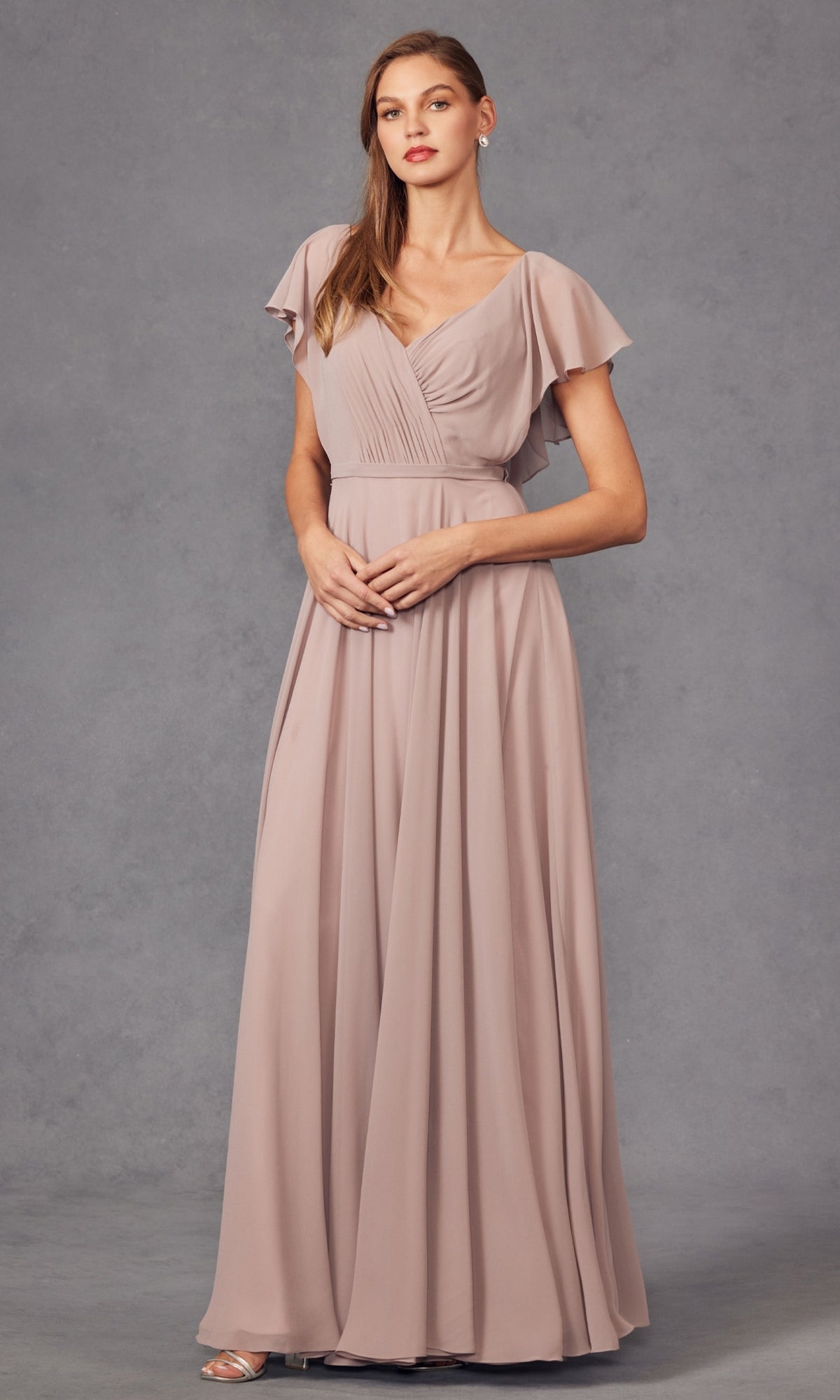 A woman models the affordable Flutter-Sleeve Long Formal Evening Gown 261 in mauve, a floor-length A-line dress with short sleeves and a V-neckline, standing against a plain gray background.