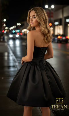 A woman in the Terani 261P6176 short prom dress stands on a city street at night, looking over her shoulder as shop lights and blurred car headlights illuminate the background.