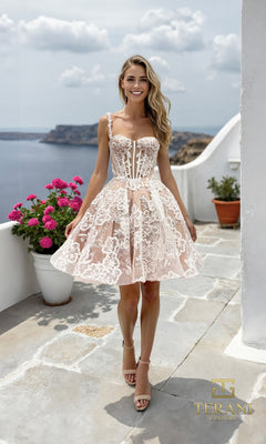A woman in the Terani 261P6180 Short Prom Dress in Ivory Nude poses outdoors on a stone terrace with potted plants, overlooking a coastal landscape.
