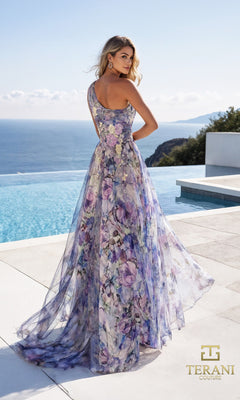A woman stands by an infinity pool wearing the Long Formal Dress: Terani 261P6696, a floor-length, one-shoulder chiffon gown in purple floral tones. The Terani Couture logo is displayed in the bottom right corner.