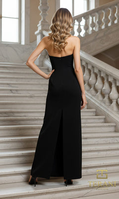 A woman in the Terani 261E6119 long formal dress, featuring crystal embellishments and a strapless design, stands on marble stairs with her wavy hair flowing down her back. The "Terani Couture" logo is at the bottom right corner.
