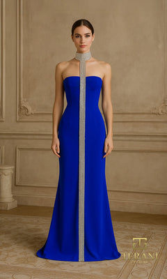 A woman stands in an ornate room wearing the Terani 261E6119 long formal dress in Royal?a floor-length, strapless gown with a vertical crystal-embellished detail and a matching silver neckpiece.