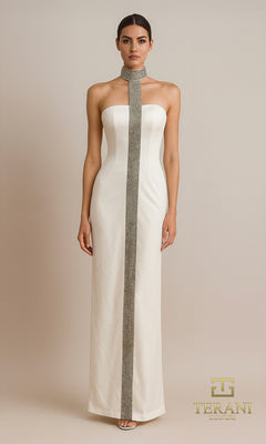A woman wears the ivory Terani 261E6119, a strapless long formal dress with crystal embellishments and a vertical silver detail, standing against a plain background.