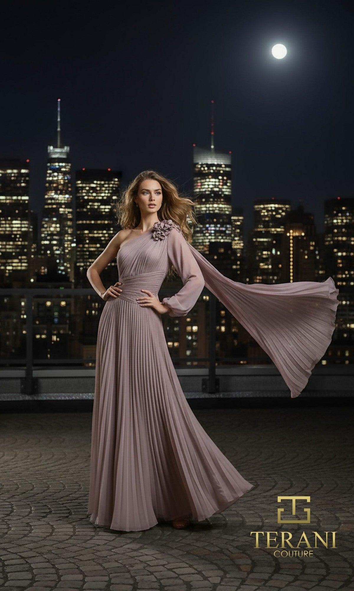 A woman in a flowing, mauve one-shoulder chiffon Long Formal Dress (Terani 261E6206) poses on a city rooftop at night, skyscrapers and a full moon behind her. Terani Couture logo is visible in the lower right corner.
