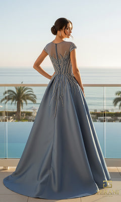 A woman in the Terani 261E6254 long formal dress, featuring stretch Mikado and beaded details, stands on a balcony overlooking the ocean and palm trees.