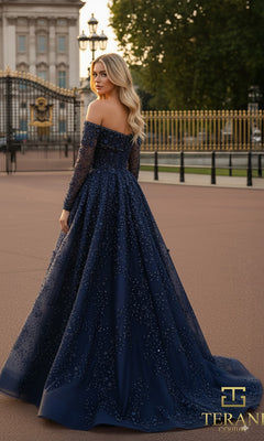 Wearing the Long Formal Dress: Terani 261GL6659, a woman stands outdoors by ornate gates; the navy blue, off-the-shoulder gown features sparkling embellishments and sheer long sleeves?an elegant choice for a mother-of-the-bride.