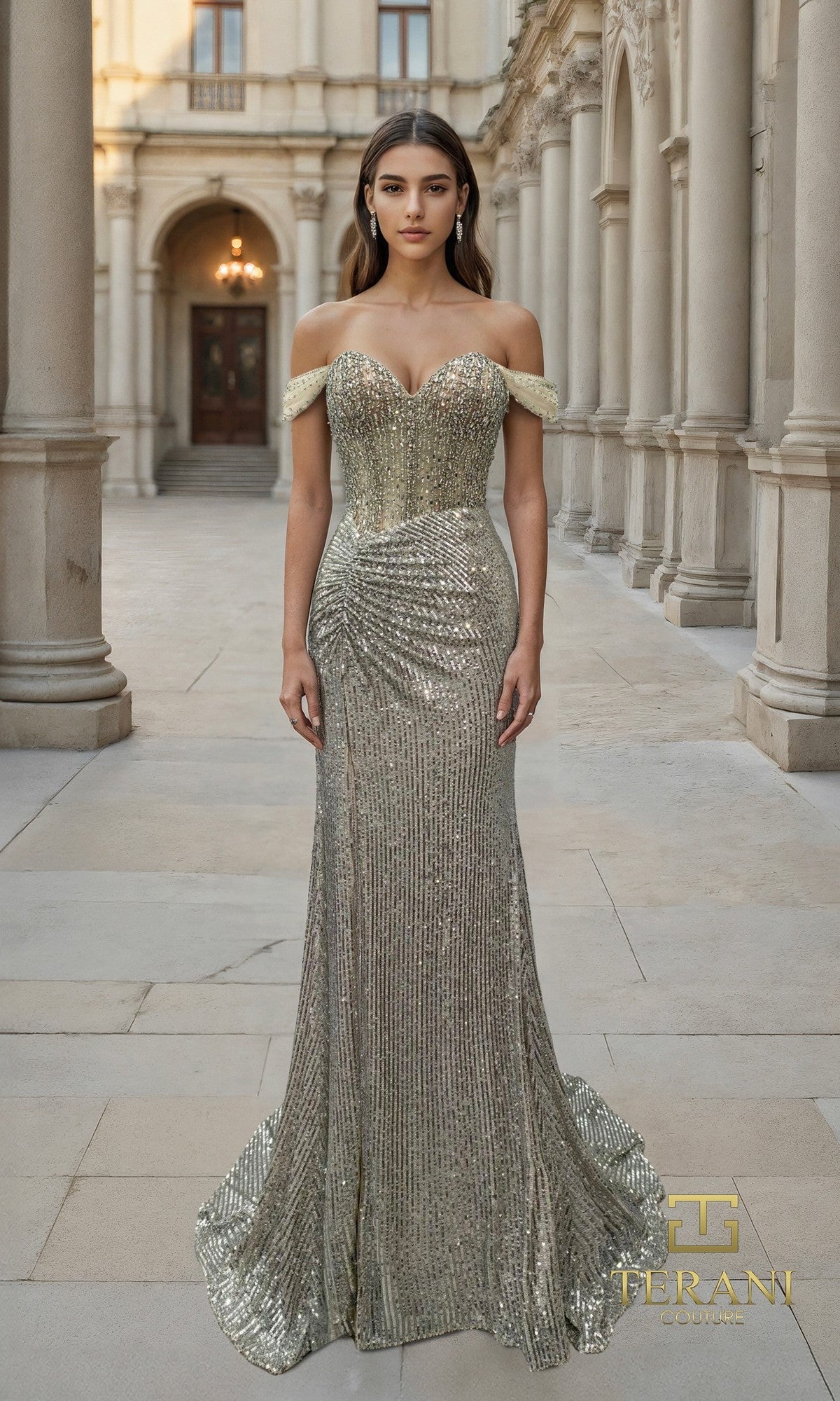 A woman stands outdoors among stone columns and arches, wearing the Terani 261P6106 long formal dress?a Champagne Silver, off-the-shoulder sequin gown with a fitted bodice and slight train.