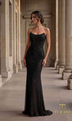 A woman stands in a classical stone corridor wearing the Terani 261P6187 black long formal dress, featuring a fitted strapless corset bodice, subtle sparkle, and a floor-length hem. The Terani Couture logo is displayed in the corner.
