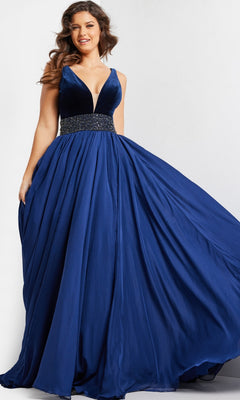 A woman wearing the Jovani Belted Long Chiffon Prom Ball Gown 26201—an a-line, sleeveless blue evening dress featuring a deep v-neck, beaded waist, and flowing floor-length chiffon skirt.