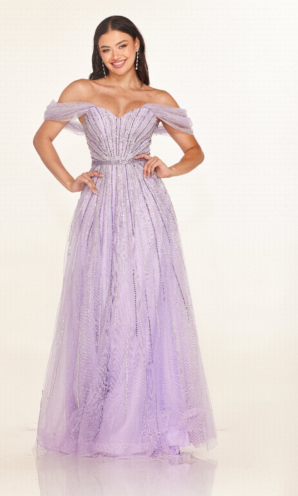 Smiling woman poses with hands on hips in the floor-length Cecilia Couture 2621 off-the-shoulder prom dress, featuring sequin embellishments, against a plain white background.