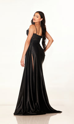 A woman models the Cecilia Couture 2627 long prom dress, featuring a high leg slit and sleeveless design, as she poses against a plain white background looking over her shoulder.