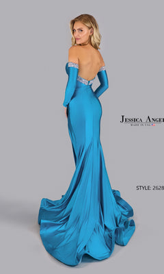 A woman poses with her back to the camera in a fitted strapless Jessica Angel 2628 prom gown, featuring blue satin fabric, a long train, and bead-trimmed accents.