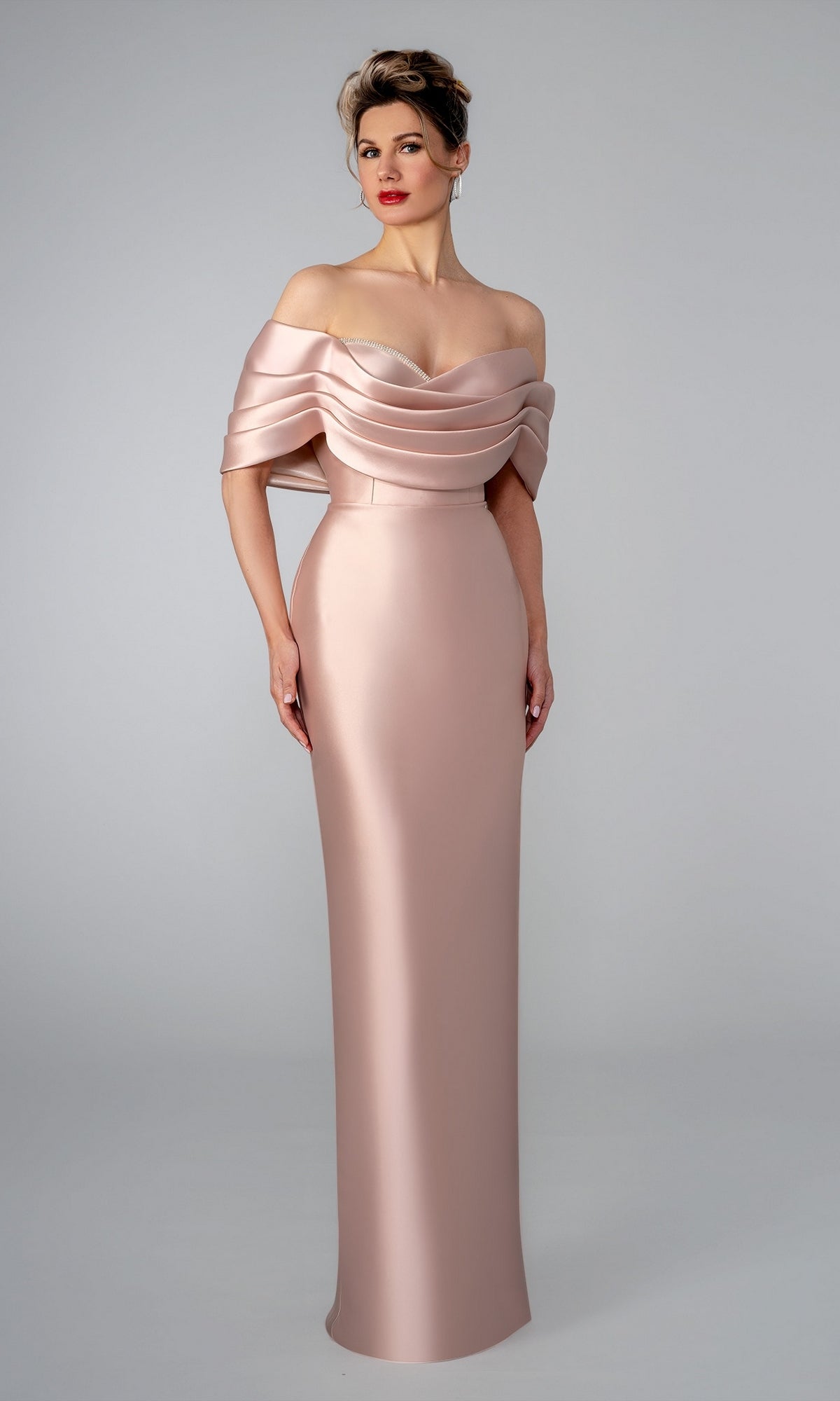 Stella Couture 26312 rose-colored, floor-length formal dress with an off-the-shoulder draped neckline.