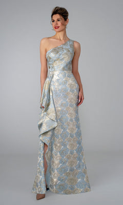 A woman wearing the Long Formal Dress: Stella Couture 26315 in blue stands against a plain gray background.