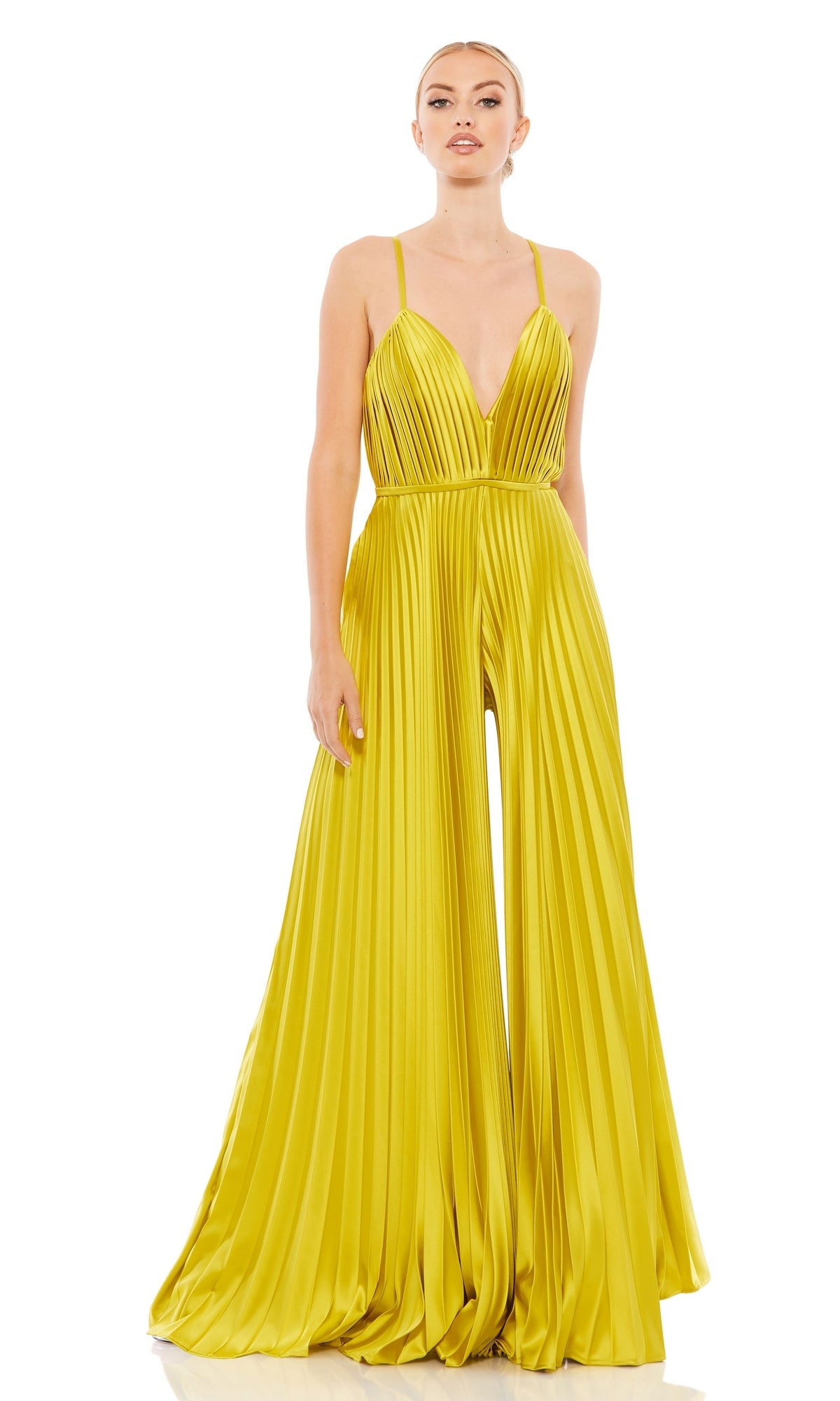 A woman stands against a white background in the Mac Duggal Pleated Wide-Leg Formal Jumpsuit 26319— a floor-length yellow jumpsuit with spaghetti straps, a deep V-neckline, and wide-leg pleated pants.