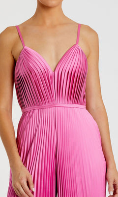 Woman wearing the Mac Duggal Pleated Wide-Leg Formal Jumpsuit 26319, a sleeveless pink style with pleated details, thin straps, a V-neckline, and wide-leg pants.