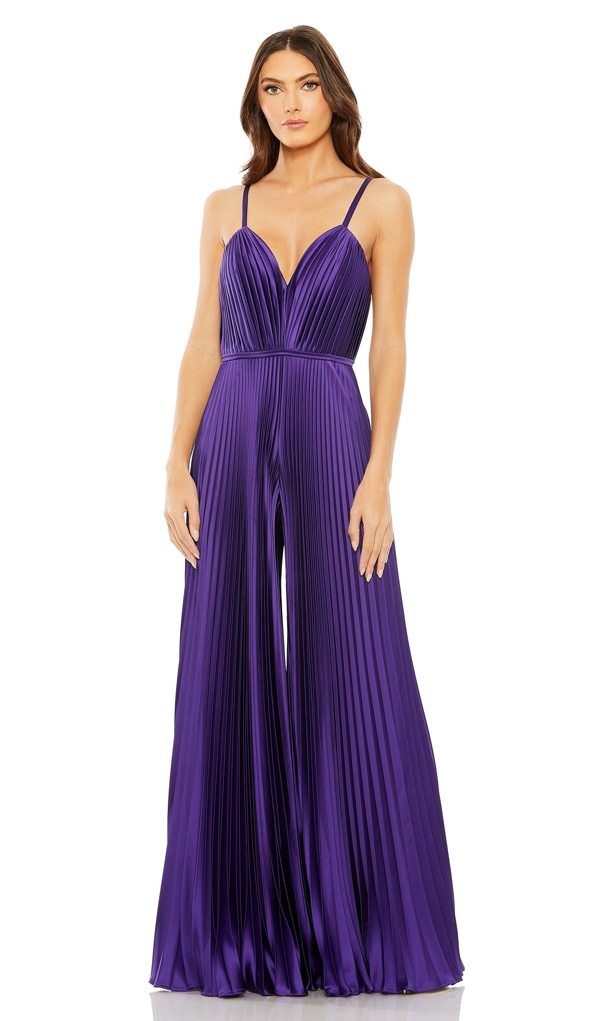 A woman wears the Mac Duggal Pleated Wide-Leg Formal Jumpsuit 26319, featuring a sleeveless design, deep purple color, thin straps, deep V-neckline, and pleated wide-leg silhouette against a white background.