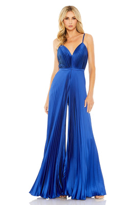 A woman models the Mac Duggal Pleated Wide-Leg Formal Jumpsuit 26319 in royal blue, featuring a sleeveless design, pleated details, thin straps, and wide legs against a white background.