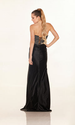 A woman with long, wavy blonde hair in a high ponytail models the Cecilia Couture 2633 long prom dress, showcasing its strapless design, high leg slit, and lace-up back while standing and facing away from the camera.