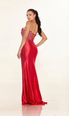 A woman poses against a white background, looking over her shoulder in the Cecilia Couture 2633 long red strapless prom dress featuring an embellished bodice.