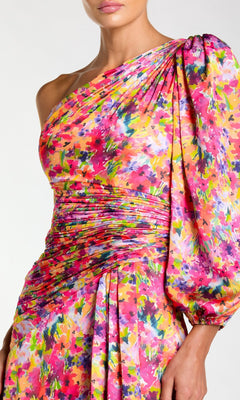 Woman wearing the Mac Duggal 2634 One-Sleeve Long Print Formal Dress, featuring a colorful floral pattern and ruched detailing at the waist and hip.