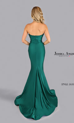 Woman in the Pleated Strapless Prom Gown: Jessica Angel 2635 stands facing away, highlighting the elegant, floor-length emerald green mermaid dress against a plain gray background.