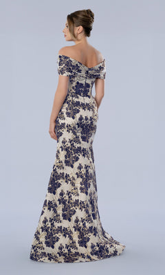 A woman in the Stella Couture 26359 long formal dress—an off-the-shoulder, floor-length gown featuring a floral brocade design—stands facing away against a plain light background, making it a beautiful option for a mother-of-the-bride dress.
