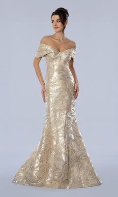 A woman stands against a plain light background wearing the Stella Couture 26360 long formal dress in gold, an off-the-shoulder evening gown crafted from shimmering metallic brocade, featuring a fitted bodice and a flared mermaid skirt.