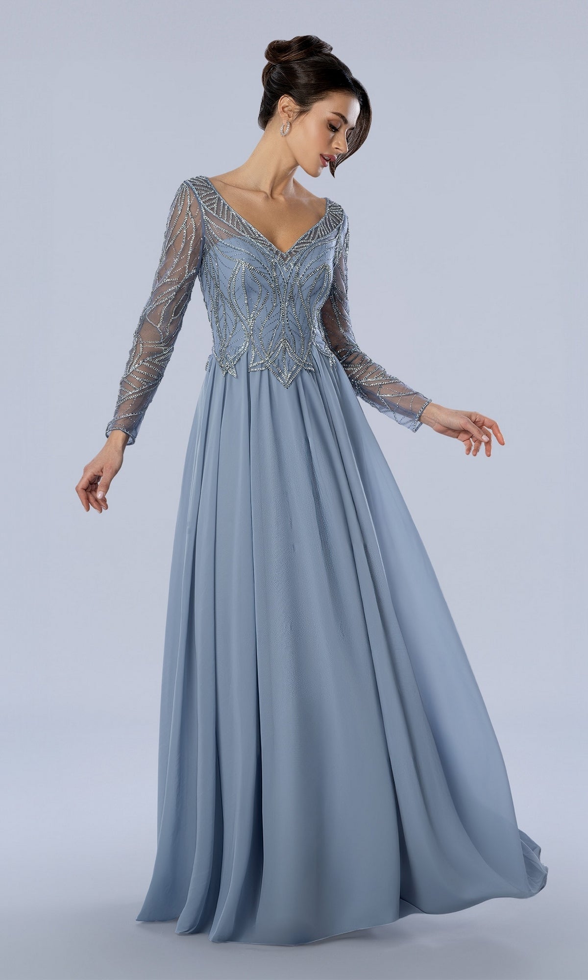 Stella Couture 26364 slate blue long formal dress with a V-neckline and intricate beaded detailing on the bodice and sleeves.