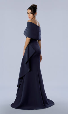 A woman wearing the Long Formal Dress: Stella Couture 26372, a dark navy off-the-shoulder floor-length gown with a draped ruffle detail at the hip.